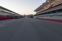 a racing track with the start in motion of it at dusk, motion blurry