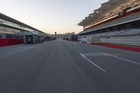 a racing track with the start in motion of it at dusk, motion blurry