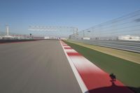 the red line is in motion on the track, with blurred background and blurry images of man driving it