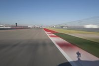 the red line is in motion on the track, with blurred background and blurry images of man driving it