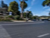 motion blurry of bus and traffic on road in urban area with trees, street, buildings and road