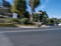 motion blurry of bus and traffic on road in urban area with trees, street, buildings and road