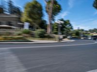 motion blurry of bus and traffic on road in urban area with trees, street, buildings and road