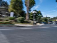 motion blurry of bus and traffic on road in urban area with trees, street, buildings and road