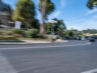 motion blurry of bus and traffic on road in urban area with trees, street, buildings and road