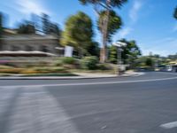 motion blurry of bus and traffic on road in urban area with trees, street, buildings and road