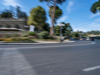 motion blurry of bus and traffic on road in urban area with trees, street, buildings and road