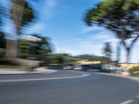 motion blurry of bus and traffic on road in urban area with trees, street, buildings and road