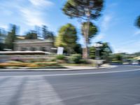 motion blurry of bus and traffic on road in urban area with trees, street, buildings and road