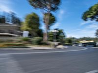 motion blurry of bus and traffic on road in urban area with trees, street, buildings and road