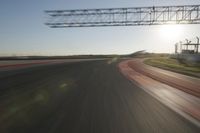 motion blurs down an airport runway and overhang the landing strip at sunrise with some clouds