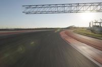 motion blurs down an airport runway and overhang the landing strip at sunrise with some clouds