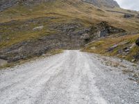 a man on his motorbike rides up a road in the mountains of norway