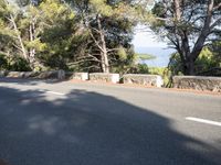 a motor cycle is seen on the road in front of a mountain and ocean view