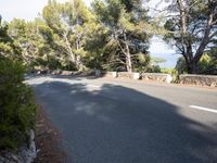 a motor cycle is seen on the road in front of a mountain and ocean view