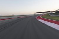 a person on a motorcycle is going through the curve on a race track under an overpass