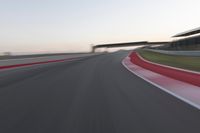 a person on a motorcycle is going through the curve on a race track under an overpass