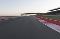 a person on a motorcycle is going through the curve on a race track under an overpass