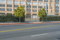 a motorcycle rider waits for the traffic to stop at an empty street corner on a city street