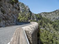 a motorcycle riding down a mountain road with no cars on it with no cars going or parked