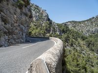 a motorcycle riding down a mountain road with no cars on it with no cars going or parked