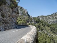 a motorcycle riding down a mountain road with no cars on it with no cars going or parked