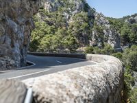 a motorcycle riding down a mountain road with no cars on it with no cars going or parked