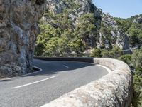 a motorcycle riding down a mountain road with no cars on it with no cars going or parked