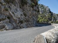 a motorcycle riding down a mountain road with no cars on it with no cars going or parked