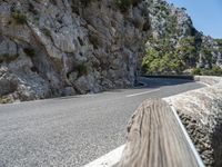 a motorcycle riding down a mountain road with no cars on it with no cars going or parked