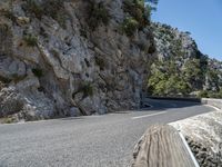 a motorcycle riding down a mountain road with no cars on it with no cars going or parked