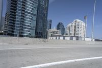 a white motorcycle is traveling on the road in a city setting next to tall buildings