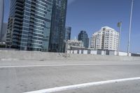 a white motorcycle is traveling on the road in a city setting next to tall buildings