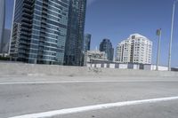 a white motorcycle is traveling on the road in a city setting next to tall buildings
