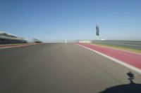 a motorcyclist riding through the race track in front of another motorcyclist