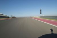 a motorcyclist riding through the race track in front of another motorcyclist