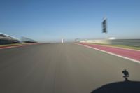 a motorcyclist riding through the race track in front of another motorcyclist