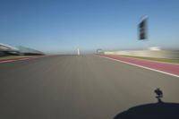 a motorcyclist riding through the race track in front of another motorcyclist