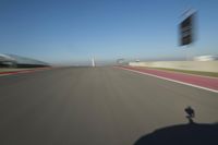 a motorcyclist riding through the race track in front of another motorcyclist