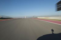 a motorcyclist riding through the race track in front of another motorcyclist