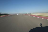 a motorcyclist riding through the race track in front of another motorcyclist