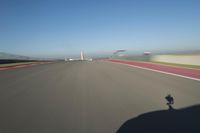 a motorcyclist riding through the race track in front of another motorcyclist