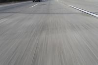 an image of motorcyclists riding on the freeway in motion down the road