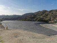 people on motor bikes at a steep drive in the mountains near a freeway that is paved