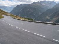 a mountain highway in the mountains with cars passing by on both sides of it and below