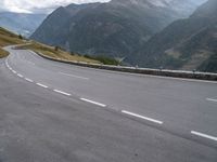 a mountain highway in the mountains with cars passing by on both sides of it and below