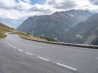 a mountain highway in the mountains with cars passing by on both sides of it and below