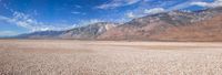 a photo of a landscape taken from the highway to the mountains with rocks and pebbles on it