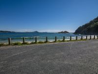 the road is empty by the ocean and mountains along the coast line it looks perfect