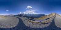 a 360 - shot photograph of a man looking back on the top of a mountain